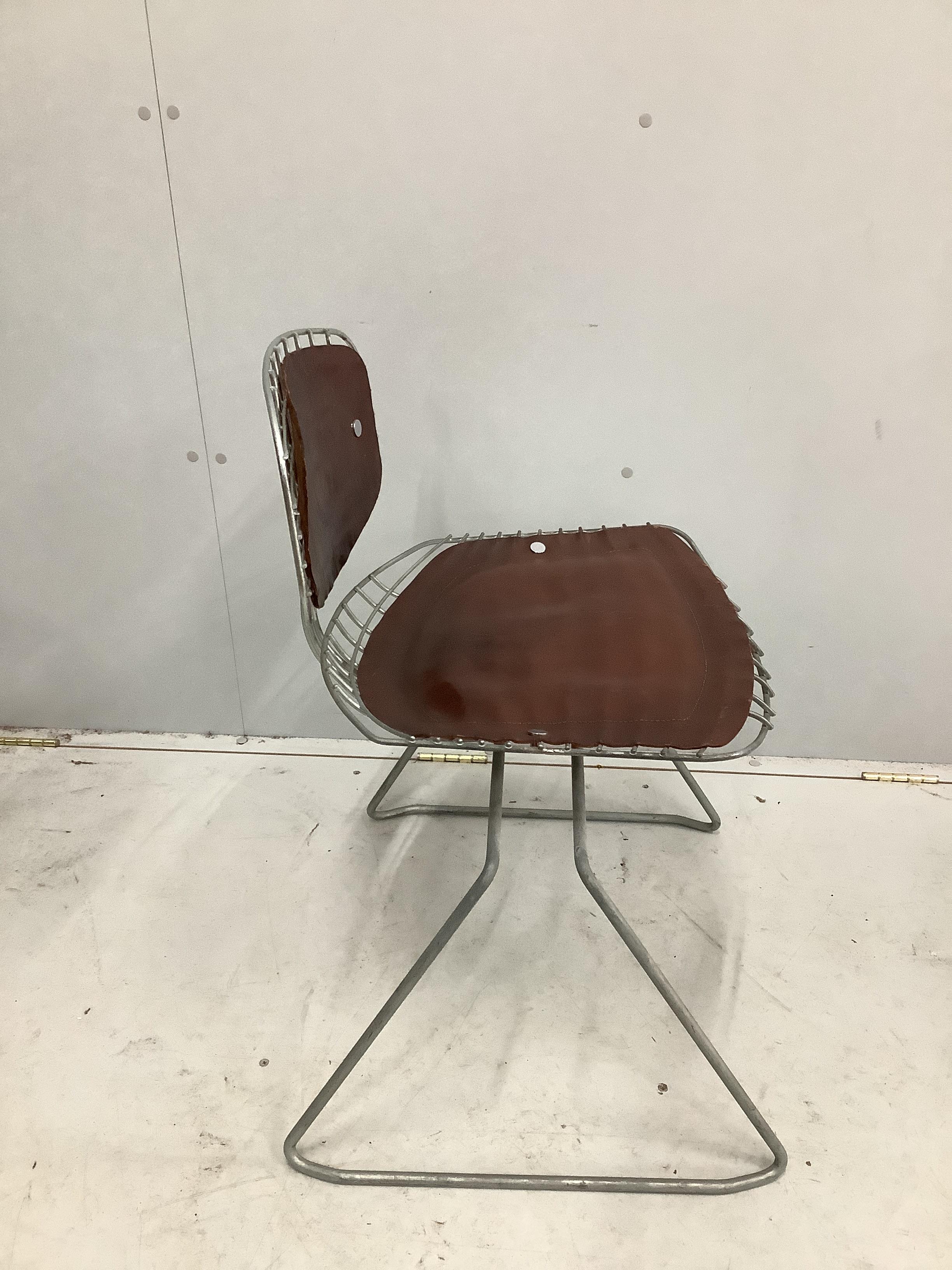 Georges Laurent and Michel Cadestin, a set of four Beaubourg wirework chairs with tan leather pads, circa 1970, width 58cm, depth 49cm, height 75cm (The Beaubourg chair was conceived by Richard Rogers and Renzo Piano and